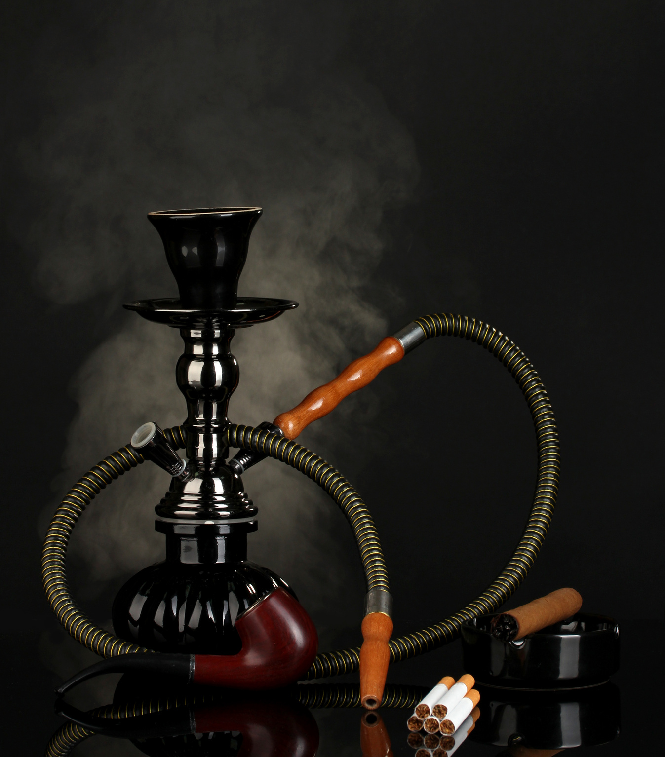 Smoking Tools - a Hookah, Cigar, Cigarette and Pipe on Black Background